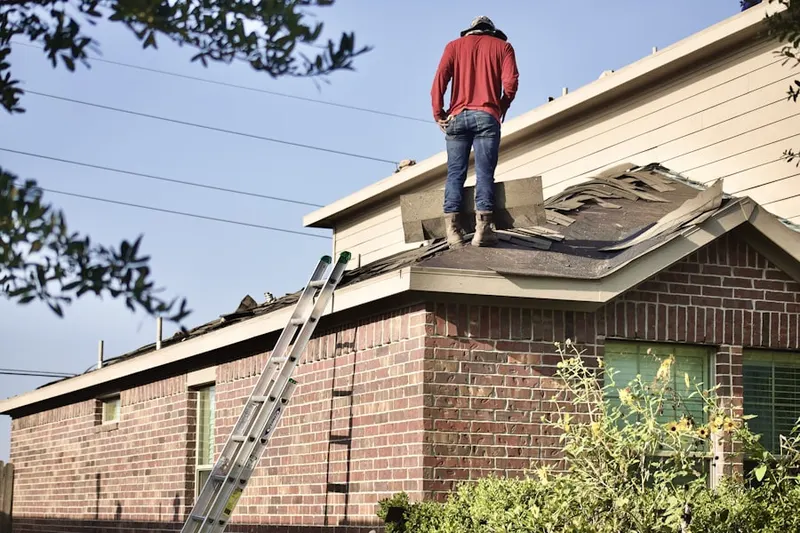 Professional roofer working on a residential roof in Palm Aire
